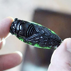 Acxico Cicada pendant detail on dark green jade showing artisan carving