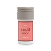 Aera Mini Sandalwood bottle pour for a calming home aroma.