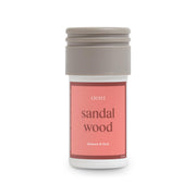 Aera Mini Sandalwood bottle pour for a calming home aroma.