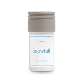 Aera Mini Snowfall bottle front view for a crisp winter scent in the living room.