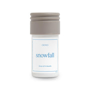 Aera Mini Snowfall bottle front view for a crisp winter scent in the living room.