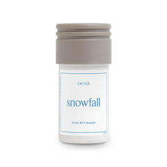 Aera Mini Snowfall bottle front view for a crisp winter scent in the living room.