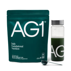 AG1 greens powder tub label highlighting ingredients for daily nutrient coverage and gut support.