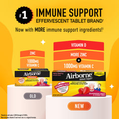 Airborne Very Berry effervescent tablets melting in a glass with bright fruit flavor.