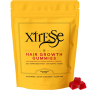AMOQUCT Xtresse gummies bottle closeup; strawberry flavor for daily hair nourishment.