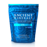 Ancient Minerals Magnesium Bath Flakes Ultra bottle being poured for a relaxing soak.