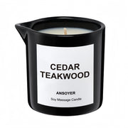 ANSOYER massage oil candle bottle in cedar-teakwood scent for skin hydration.