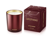 APOTHEKE Bitter Cherry Candle jar showcases luxurious fragrance in a living room.