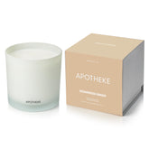APOTHEKE cedarwood ginger candle in a glass jar enhances ambiance with long-lasting fragrance.