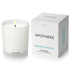 APOTHEKE Bergamot Tangerine candle in a white jar for a bright, long-lasting living room fragrance