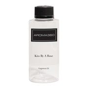 Aroma360 Kiss by a Rose bottle showcasing a luxurious fragrance in a premium setting.