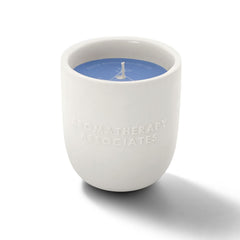 Close-up of the wick beside the ceramic holder shows premium design.