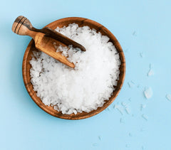 ASUTRA lavender bath flakes used in a foot soak for tired feet relief.