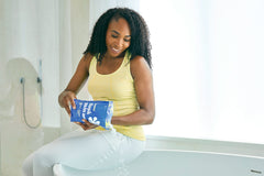 ASUTRA Magnesium Chloride Bath Flakes pour demonstrates easy measuring for soothing foot and body soaks.