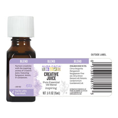 Aura Cacia Creative Juice bottle on desk enhances ambient, natural fragrance.