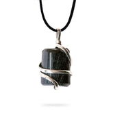 Ayana Wellness raw black tourmaline pendant close-up for grounding.