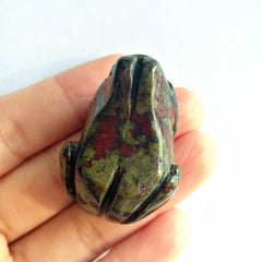 Bacatgem pocket-size frog gemstone decor beside a notebook