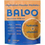 Baloo electrolytes orange packet beside a glass of water for refreshing hydration
