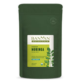 Banyan Botanicals Moringa powder bottle close-up showing vibrant powder for daily energy support.