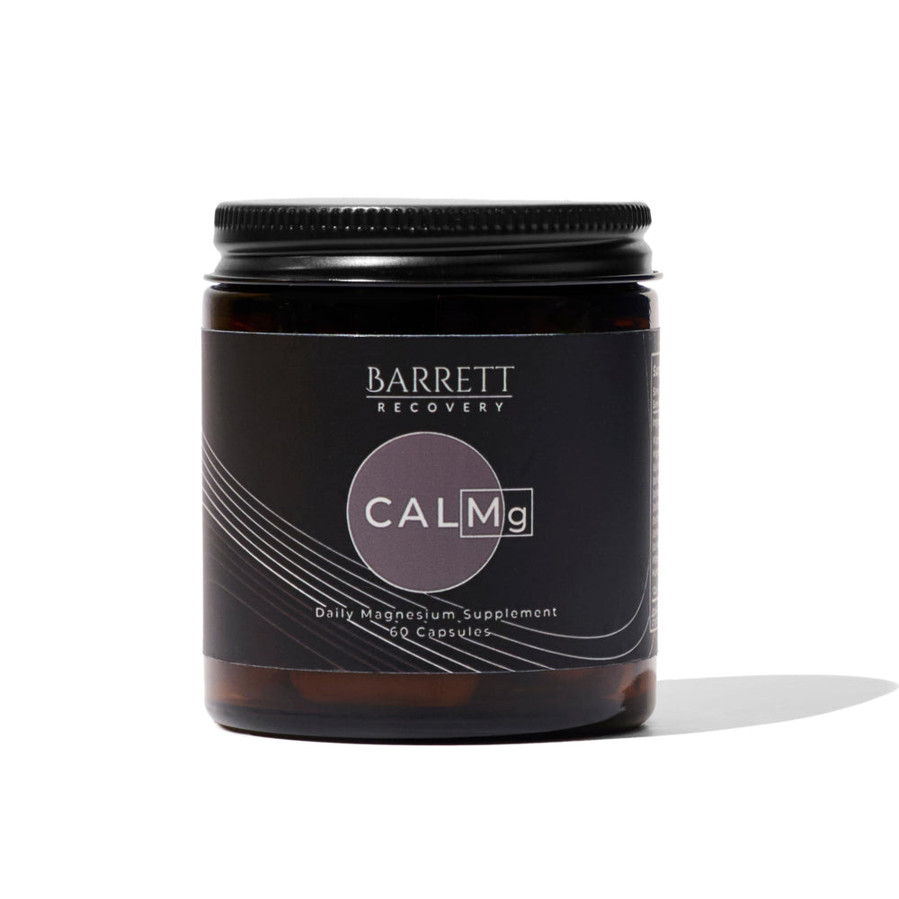 Barrett Recovery CALMg bottle on nightstand ready for calm sleep.