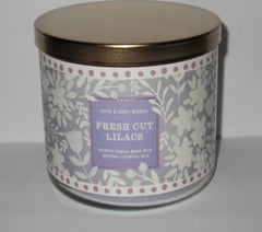 Bath & Body Works White Barn 3-Wick Candle close-up with three flames for cozy ambience.
