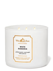 Close-up of Bath & Body Works White Barn candle showing wax and flame with gardenia notes
