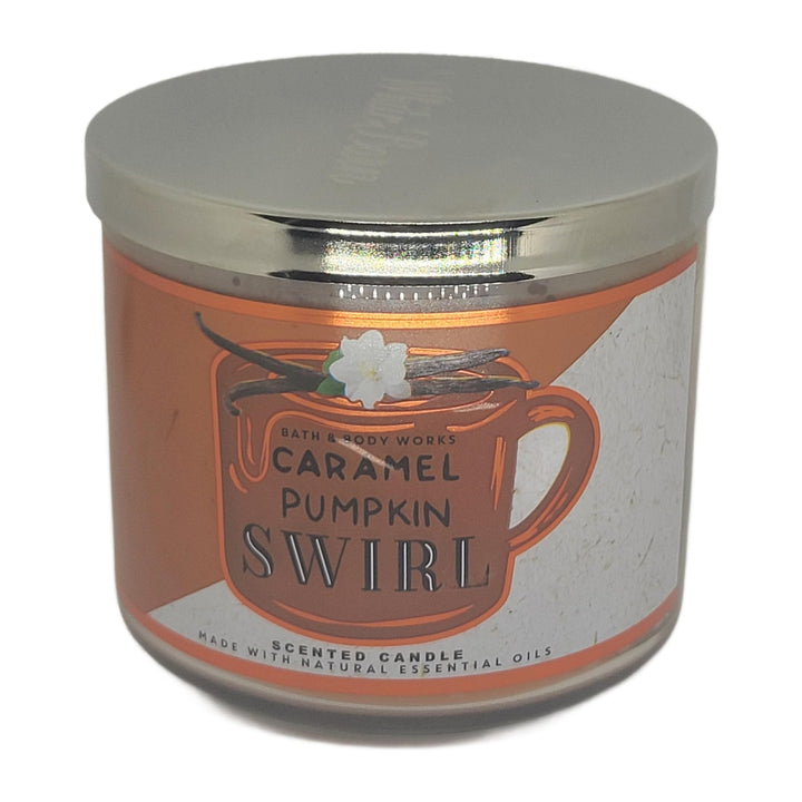 Bath & Body Works White Barn 3-Wick Candle jar glowing with autumn Caramel Pumpkin Swirl.