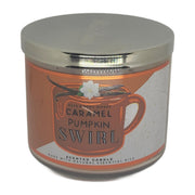 Bath & Body Works White Barn 3-Wick Candle jar glowing with autumn Caramel Pumpkin Swirl.