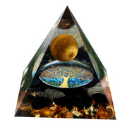 Besorgone orgonite pyramid close-up with tiger eye and obsidian for energy balance.