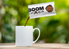 Opened BOOM Chaga packet ready to mix with a beverage.