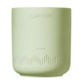 Caftari Elixir candle with bergamot, mandarin, and tea notes brightening a room