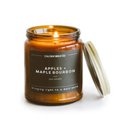 Calyan Wax Co. Apples & Maple Bourbon candle in amber jar adds warm ambiance.