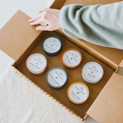 Calyan Wax Co. Dignity Evergreen & Eucalyptus in a ceramic jar freshens a bedroom.