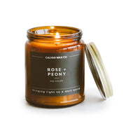 Calyan Wax Co. Rose & Peony candle in an amber jar for lasting ambiance.