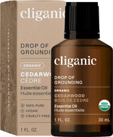 Cliganic Cedarwood essential oil bottle for diffusion and calming ambiance.