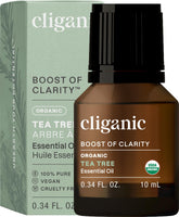 Cliganic Organic Tea Tree Oil bottle pour highlights purity for diffusers and calm spaces.