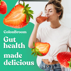 Pouring ColonBroom strawberry powder into glass for a berry fiber boost