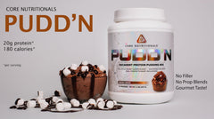 Core Nutritionals Pudd'n Rocky Road spoon lifting smooth pudding for a satisfying snack.