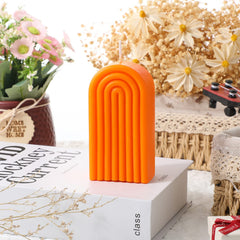 Coume U-shaped candle in orange complements modern decor.
