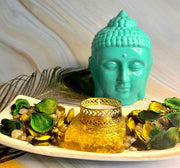 CRYSTALMIRACLE Citrine Orgonite tea light holder outer view with warm amber glow.