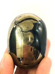 CRYSTALMIRACLE Golden Pyrite Oval PalmStone close-up for meditation focus and grounding energy.