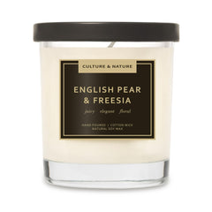 Culture & Nature soy candle in pear-freesia jar enhances cozy living room ambiance.