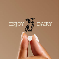 DairyPill pill in hand demonstrates compact, easy-to-swallow serving.