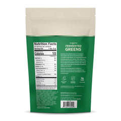 Pouring Dr. Mercola Fermented Greens Powder into a glass for easy mixing