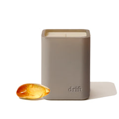 Drift amber scented candle with a sleek lid for modern room decor.