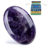 DUQGUHO amethyst palm stone in hand for calm focus during meditation.