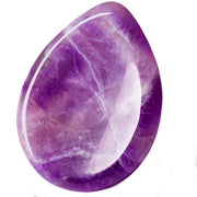 DUQGUHO amethyst worry stone held in hand for calm focus.