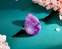 DUQGUHO amethyst worry stone polished surface highlights calming touch for meditation.