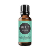 Edens Garden Age Defy essential oil bottle showing woodsy and floral notes for calming rituals.