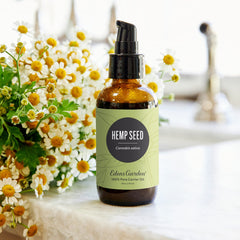 Dropper pouring hemp seed carrier oil onto skin for overnight hydration